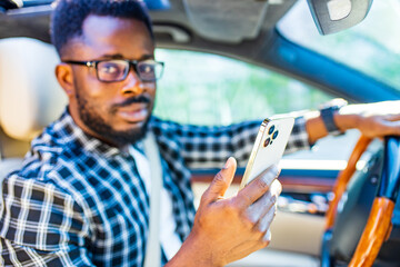 brazilian handsome man useing smartphone app to drive a new travel road