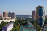 Fototapeta Miasto - Panoramic top view of the city of Reutov Moscow region with modern tall houses among green trees on a bright sunny summer day
