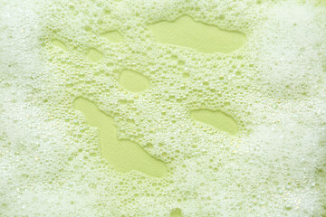 Sticker - Fluffy bath foam on light green background, top view