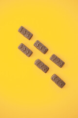 Poster - Chocolate candy bar on yellow background