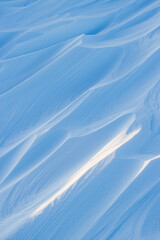 Wall Mural - snow texture. wind sculpted patterns on snow surface. wind in the tundra and in the mountains on the