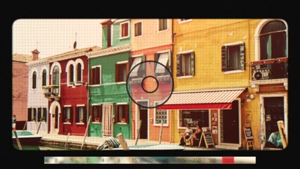 Wall Mural - Burano, Venice, Italy - July 2, 2022: Retro photo camera screen with brightly colored houses and water canal with boats in Burano, people walk and rest on streets