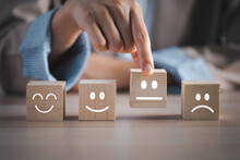 Closeup Businesswoman Hand Picking Happy Emotion Face On Wooden Cube Arranged On Table For Satisfaction Survey