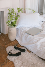 Aesthetic Home Interior. Bed With Fresh White Linen, Beautiful Blooming Branches In Vase, Sandals On Carpet. French Apartment.