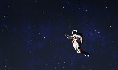 Wall Mural - astronaut spacewalk in space and pointing his finger.