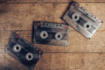 Poster - Beautiful Audio cassette tape on a brown old wooden table. Minimalism retro style concept. 80s. Background pattern for design.
