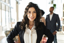 Confident Businesswoman With Long Hair Standing At Office