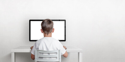 Aufkleber - Boy is working on the computer, his back is turned. Isolated computer display for mockup. Copy space on the wall. The concept of working and learning on the computer