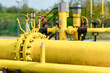 Two black and yellow gas pipes are connected by large bolts.Background for suppliers of gas products and pipes.Close-up,selective focus.