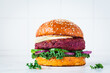 Beetroot vegan burger with kale, onion and cucumber. Alternative fast food.  Purple food.