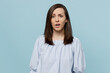 Young sad dissatisfied disappointed upset unhappy woman she 20s wear casual blouse look camera with open mouth isolated on pastel plain light blue background studio portrait. People lifestyle concept