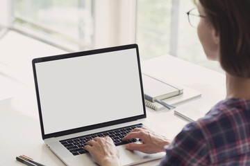 Wall Mural - Young woman using laptop computer with white mockup screen at home. Business woman working in office. Freelance, student lifestyle, e-learning, web site, technology and online meeting concept