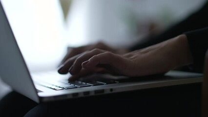 Person typing on laptop closeup female hands types on computer