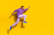 Full length body size view of handsome trendy strong cheerful guy jumping striving isolated on vivid yellow color background