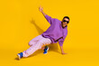 © deagreez - Full length body size view of attractive cheerful guy dancing low brake clubbing isolated over bright yellow color background