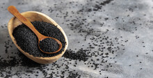 Indian Spice Black Cumin (nigella Sativa Or Kalonji) Seeds In Bowl With Spoon On Wooden Table Close Up