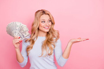 Wall Mural - Portrait of pretty positive lady arm palm hold cash demonstrate empty space isolated on pink color background