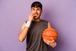 Young hispanic basketball player man isolated on purple background biting fingernails, nervous and very anxious.