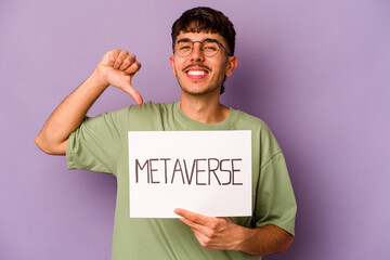 Wall Mural - Young hispanic man holding meta verse placard isolated on purple background feels proud and self confident, example to follow.