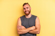 © Asier - Young caucasian man isolated on yellow background who feels confident, crossing arms with determination.
