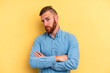 © Asier - Young caucasian man isolated on yellow background unhappy looking in camera with sarcastic expression.