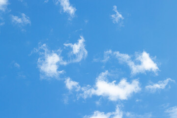 Wall Mural - Blue and white sky abstract background, beautiful fluffy thinly clouds on cyan heaven backdrop in afternoon in spring season. Light cloud in good weather day. Natural landscape environment in the air