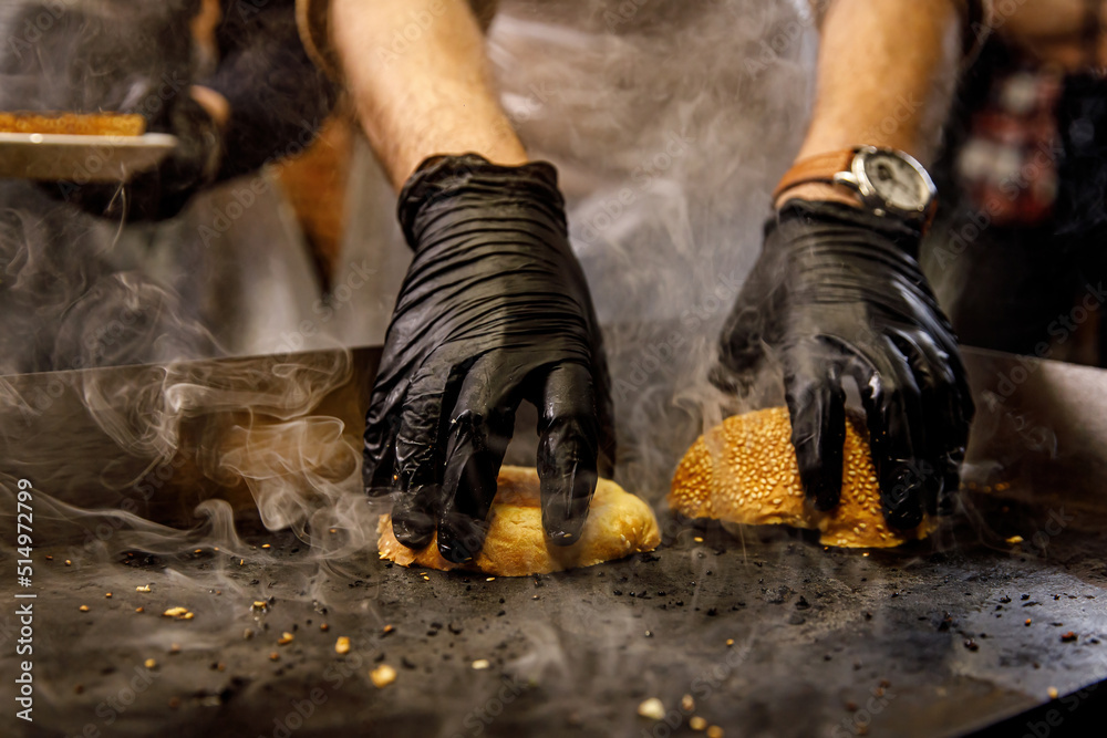 Hamburger buns toasting face down on a hot grill.