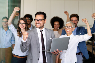 Wall Mural - group of successful multiethnic business people celebrating a good job in the office