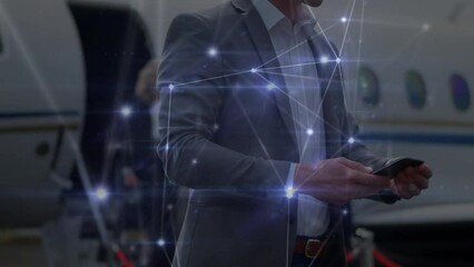 Poster - Animation of connections over midsection of caucasian businessman using smartphone by plane