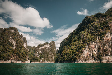 Khao Sok, Thailand - December 20th, 2019 : cliffs on the banks of the lake in the Thai national park of Khao Sok