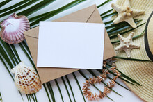 Greeting Card Layout. Summer Holiday Concept. Romantic Composition Of Straw Hat, Palm Leaf And Sea Shells On White Background