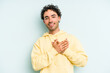 © Asier - Young caucasian man isolated on blue background laughing keeping hands on heart, concept of happiness.