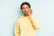© Asier - Young caucasian man isolated on blue background with fingers on lips keeping a secret.