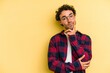 © Asier - Young caucasian man isolated on yellow background looking sideways with doubtful and skeptical expression.