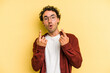 © Asier - Young caucasian man isolated on yellow background pointing upside with opened mouth.