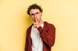 © Asier - Young caucasian man isolated on yellow background keeping a secret or asking for silence.