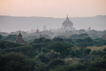 Panoramic View On Temple Ruins In The Ancient Archeological City Of Bagan, Myanmar At Sunrise With A Foggy Sky