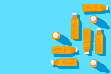 Wall Mural - Yellow detox juice drink in bottles on a blue background. Top view, flat lay.