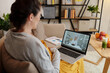 © DragonImages - Young pregnant woman talking to her doctor online using laptop while sitting on sofa in living room