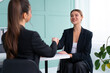 © Andrii - Job interview. Business, career and placement concept. Young blonde woman handshaking candidate hand, while sitting in front of candidate during corporate meeting or job interview