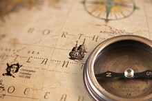 Magnetic Old Compass On World Vintage  Map. Travel, Geography, Navigation, Tourism And Exploration Concept Background.