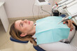 © Tania - patient lies in a dental chair waiting for tooth treatment
