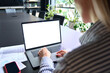 © insta_photos - Young Caucasian businesswoman ceo executive manager using typing email letter using laptop computer with empty blank white mockup screen for advertising at desk. Business concept. Over shoulder view.