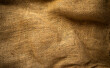 Photo of the texture of a fabric bag in vintage processing. Retro background for text. Cloth background made of burlap.