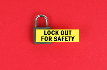 Poster - On the red surface there is a lock with a sticker with the inscription - lock out for safety