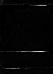 Poster - Folded paper with grungy texture in black background. can be used to replicate the aged and worn look for your creative design. old paper for photo texture overlay in retro style