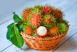 Fresh and ripe rambutan sweet tropical fruit peeled rambutan with leaf, Rambutan fruit on basket background harvest from the garden rambutan tree