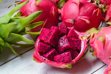 Wall Mural - dragon fruit slice on fruit peel with pitahaya background , fresh red purple dragon fruit tropical in the asian thailand healthy fruit concept