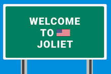 City Of Joliet. Welcome To Joliet. Greetings Upon Entering American City. Illustration From Joliet Logo. Green Road Sign With USA Flag. Tourism Sign For Motorists