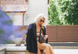 © Galina Zhigalova - Adult elegant blonde woman in black jacket and sunglasses on summer city street